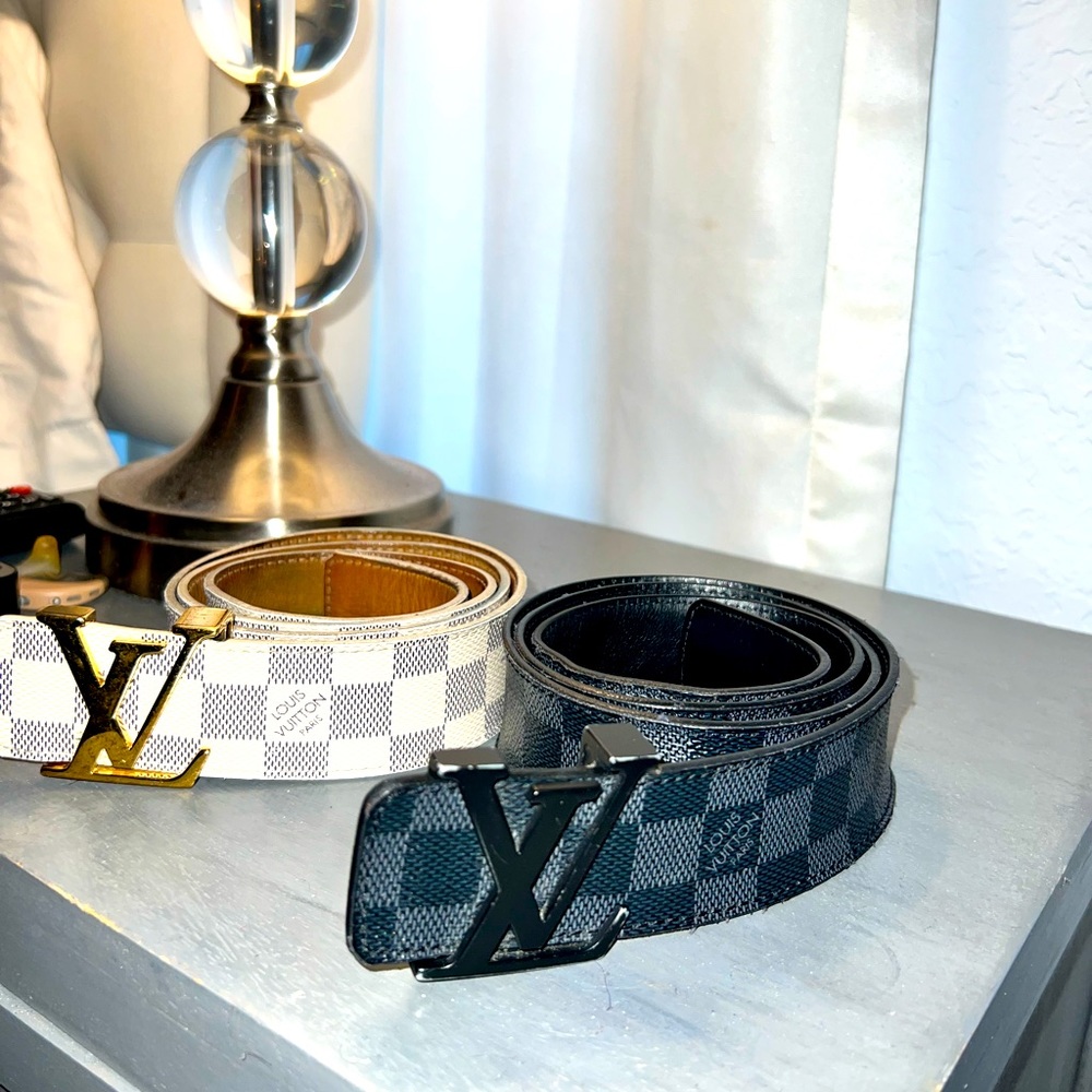 Two Louise Vuitton Belts. One white patterned color and one black one as well.